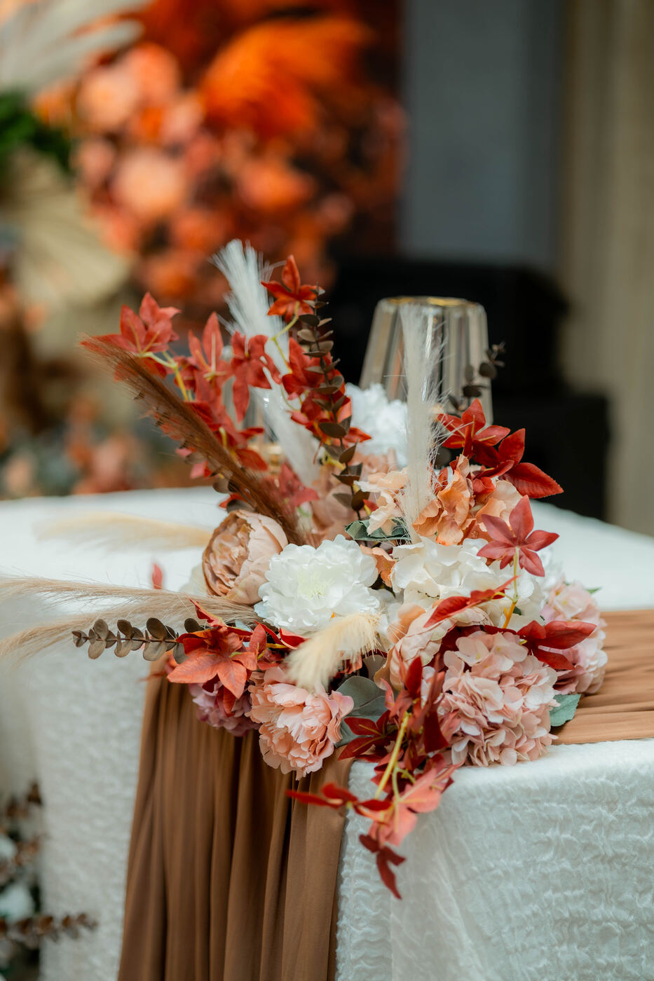 Vertical floral stage detail from a wedding setup