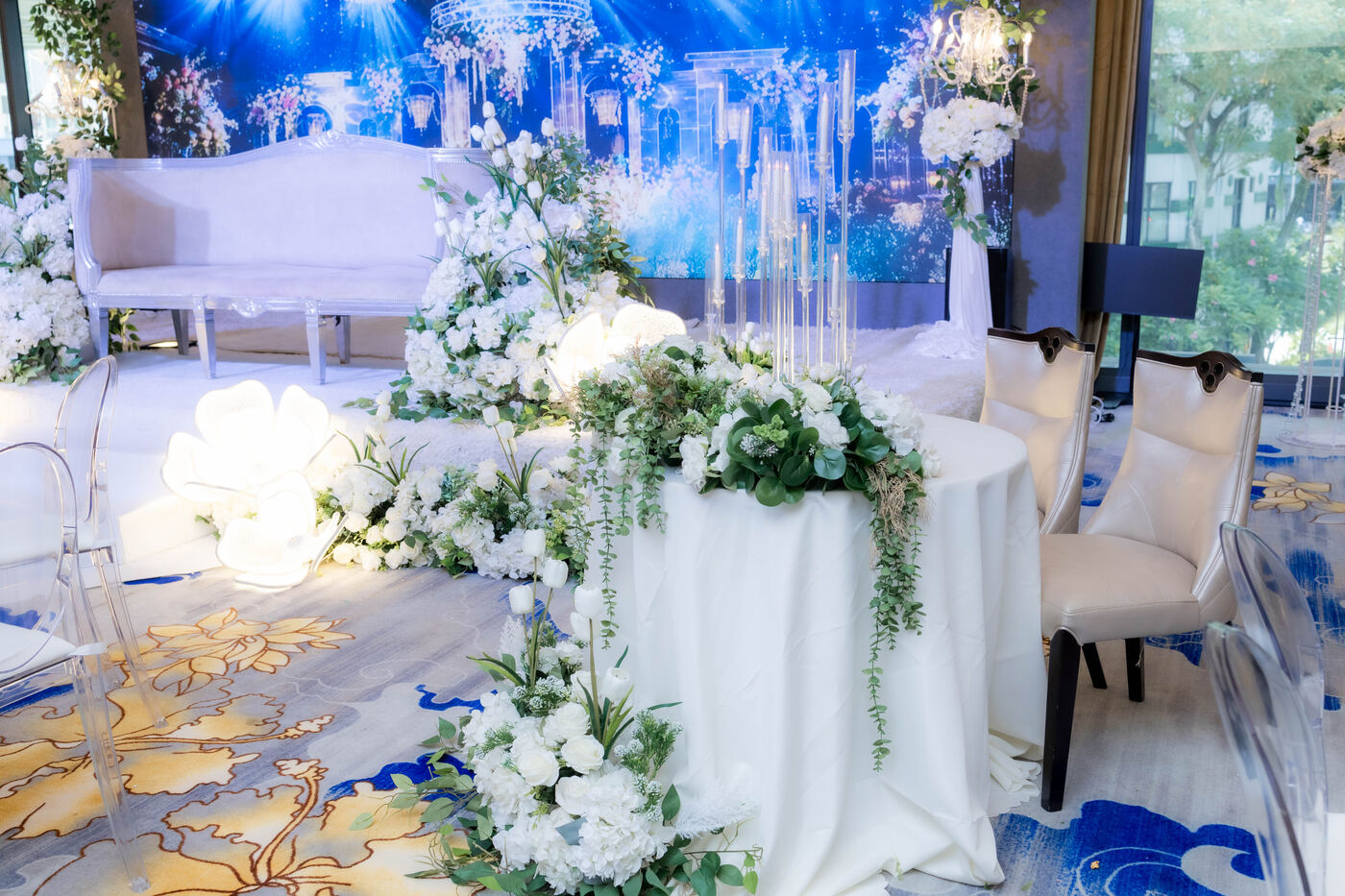 White floral solemnisation setup with stage seating at De Villa