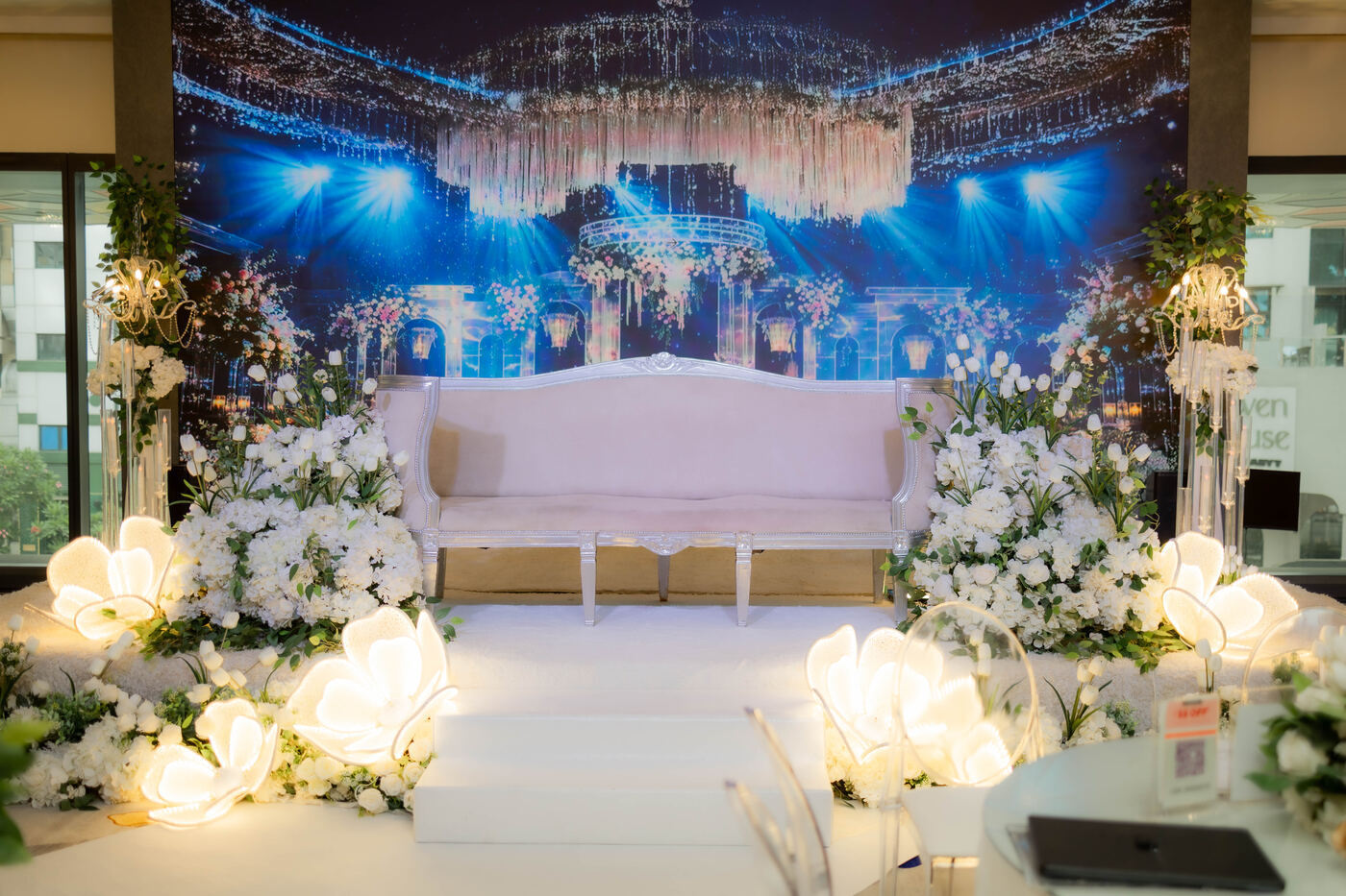 White ceremony stage with floral styling